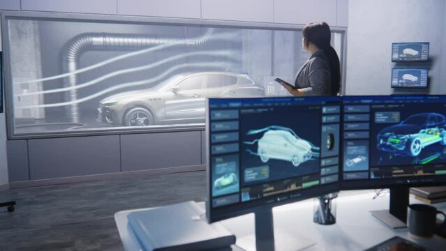 Engineers check aerodynamics of eco-friendly electric car in lab for modern modifications using wind tunnel with steam. Computer system for changing parameters. Car testing and technologies concept.