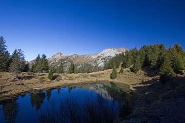 Mountain lake in Switzerland on a sunny autumn day