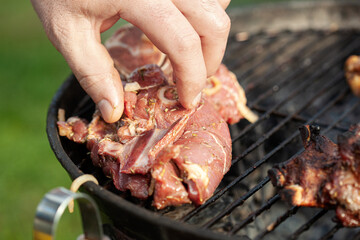 Cooking different meat on barbecue. Grilled and roasted lamb steaks on bbq. Take one piece