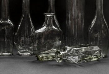 Bottles of unpainted glass on a dark background