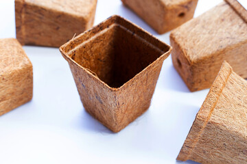 Coco coir pots on white background.