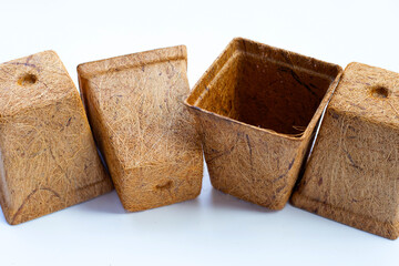 Coco coir pots on white background.