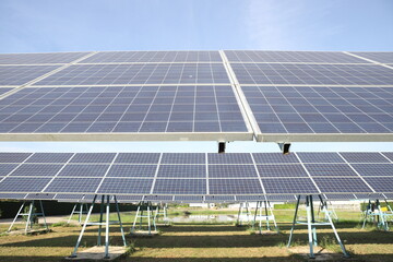 Solar Panels and Wind Turbines at Sunset or Sunrise.Concept of Renewable Energy , Solar cell farm power plant eco technology,concept of sustainable resources and clean energy system.