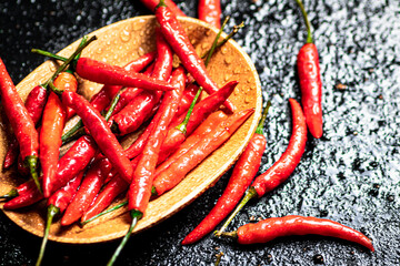 Chili peppers on a wooden plate. 