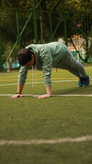 young man doing push ups
athlete training in the park
