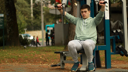 young man exercising in the park
athlete exercising on machine
