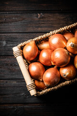 A full basket of onions on the table. 