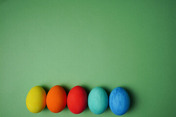 Easter composition. Colorful easter eggs on green background. The minimal concept. Flat lay. Copy space.