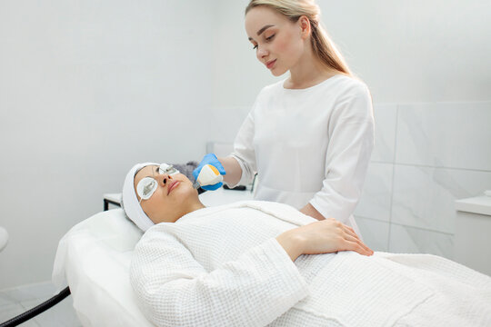 woman patient lies in a modern cosmetology clinic on a facial skin care procedure