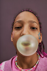 Fisheye black teenage girl blowing bubblegum bubble