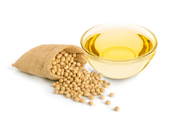 Glass bowl of soybean oil with soybeans in burlap sack on white background.