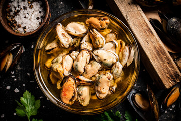 Pickled mussels with parsley and spices on the table. 
