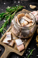 Salted herring glass jar with a swist of rosemary.