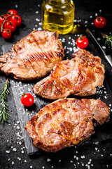 Grilled pork steak with cherry tomatoes and rosemary. 