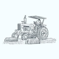 Vintage hand drawn tractor and some square bales of hay