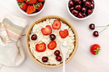 Cottage cheese with summer strawberries cherry berries.curd cheese in bowl with honey.Healthy dairy Calcium,Protein product,food breakfast,lunch,lifestyle,dieting, detox,proper nutrition.Top view