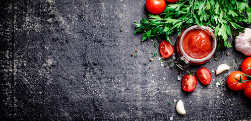 Tomato sauce in a glass jar with parsley and garlic. 