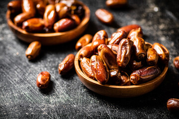 Two plates of dates on the table. 