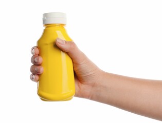 Woman with bottle of mustard on white background, closeup