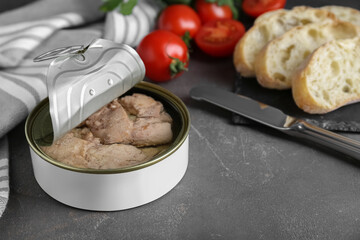 Open tin can of tasty cod liver on grey table, closeup. Space for text