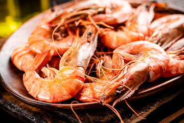 Boiled shrimp in a wooden plate. 