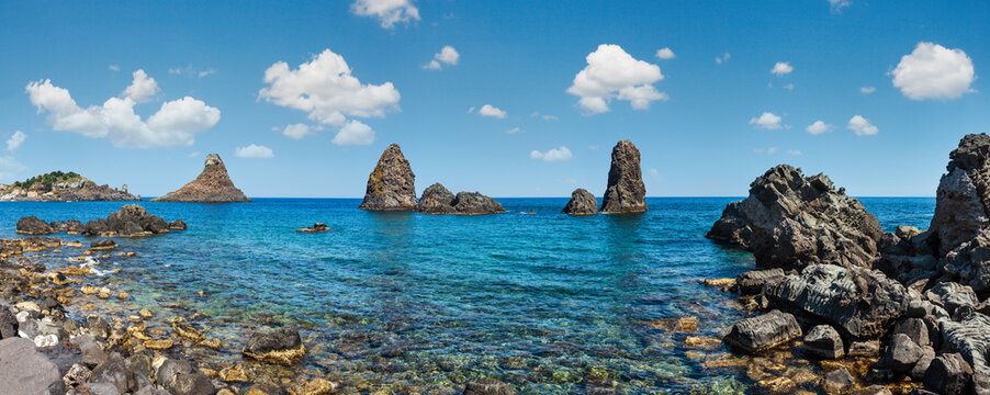 Cyclopean Coast and the Islands of the Cyclops on Aci Trezza town (Italy, Sicily,10 km north of Catania). Known as Isoles Dei Ciclopi Faraglioni.