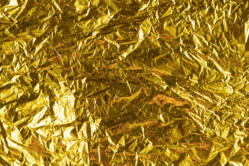 gold leaf background texture with shiny crumpled uneven surface