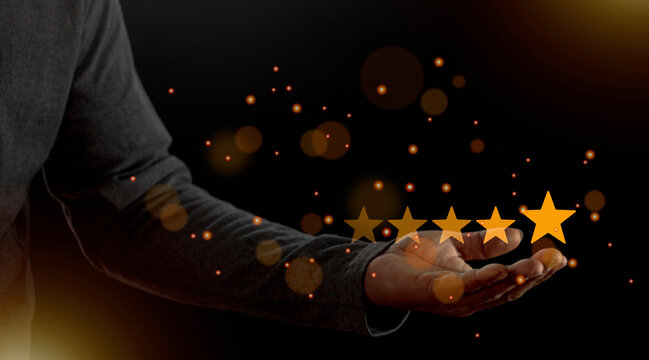 Satisfaction close up on customer man hand pressing on screen with five star rating feedback icon and press level excellent rank for giving best score point to review the service concept