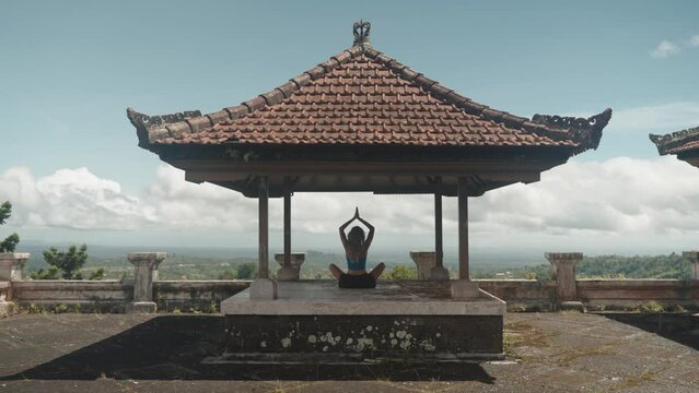 Young healthy girl doing yoga and meditation in the mountains healthy lifestyle, zen concept 