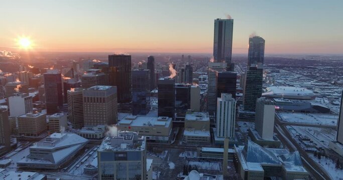 An aerial footage of downtown Edmonton buildings and skyscrapers during cold winter at sunset