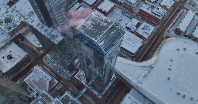 Aerial footage of the high skyscrapers buried in snow at sunrise in Edmonton Alberta