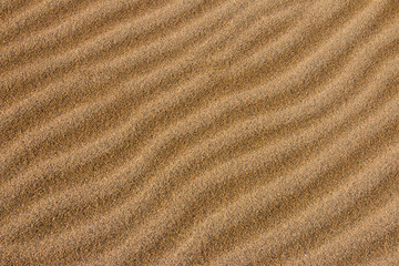 Fototapeta na wymiar Wave traces and flowing water marks, the sand dunes change their appearance moment by moment. Time while Depending on the four seasons and day and night