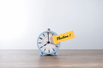 Message on FLEXITIME! written on the yellow post-it note and pasted on the alarm clock face. 