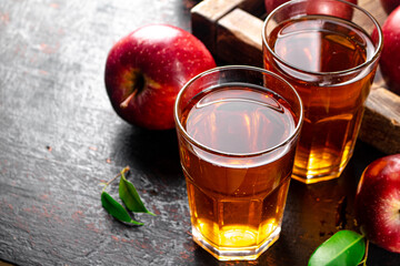 A glass of apple juice on the table. 