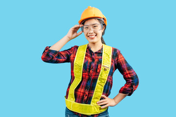 Young female engineer in helmet stand touch on safety goggles posture