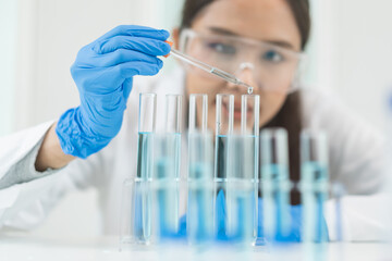Medical development research laboratory, chemist or science scientist student hand in glove, drop water into pipette for test analysis liquid sample in clinic lab. Microbiology, analysing for medicine