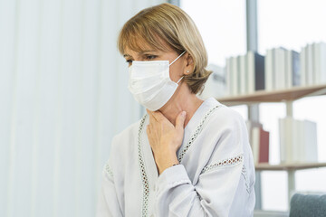Sick, hurt or pain, weakness caucasian mature adult, senior woman wearing mask with sore throat,...