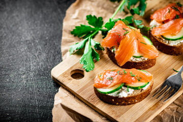 Salmon sandwich on a cutting board.