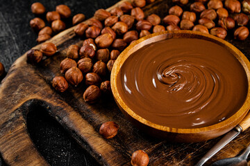 Hazelnut butter on a cutting board with a spoon. 