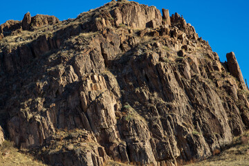 Big Rocky stone under blue sky background.