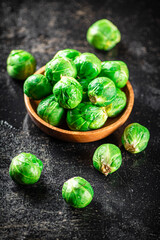 Fresh Brussels cabbage in a wooden plate. 