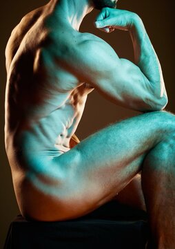 Body, art and strong with a nude man in studio on a dark background for artistic expression or freedom. Creative, sexy and model with a naked male posing to promote artwork, sensuality or fitness