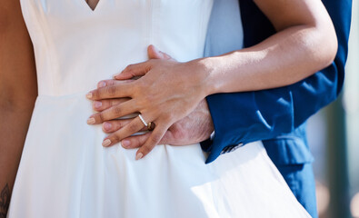 Hands, married and interracial wedding of couple for outdoor celebration of partnership, care and love. Marriage commitment and support of bride with groom at event with embrace for togetherness.