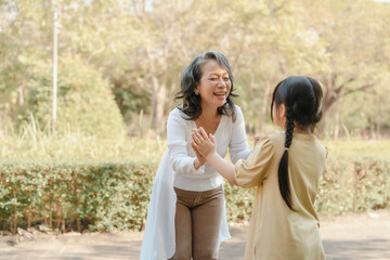Portrait of asia grandmother and grandchildren holiday vacation together in the park in the summer in Southeast Asia Pacific.