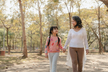 Fototapeta premium Portrait of asia grandmother and grandchildren holiday vacation together in the park in the summer in Southeast Asia Pacific. Walking