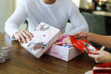 Surprise! romantic couple Hold present box with gift happy boyfriend and girlfriend. Valentine present. Gift box and red ribbon for romantic couple