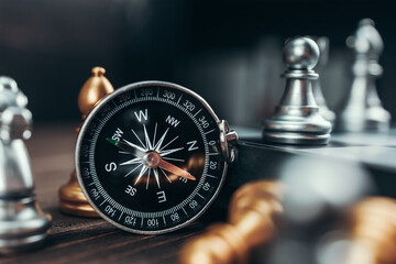 compass and chess piece on chess board game for ideas, challenge, leadership, strategy, business, success or abstract © Charnchai saeheng