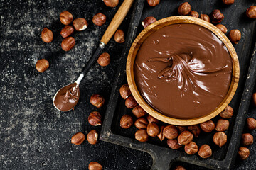 Hazelnut butter on a cutting board with a spoon. 