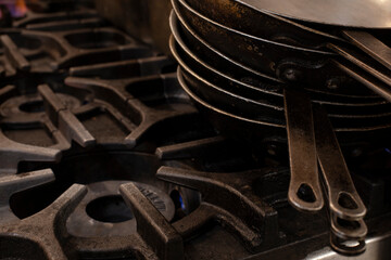 Stack of cast iron pans on the restaurant stove