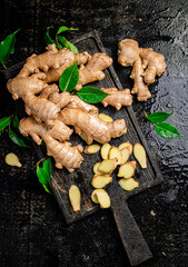 Whole and chopped ginger on a cutting board. 